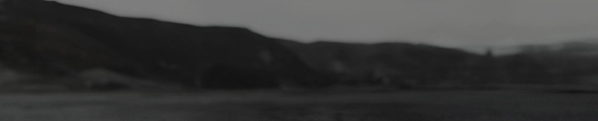 Dark mountain ridge in grayscale