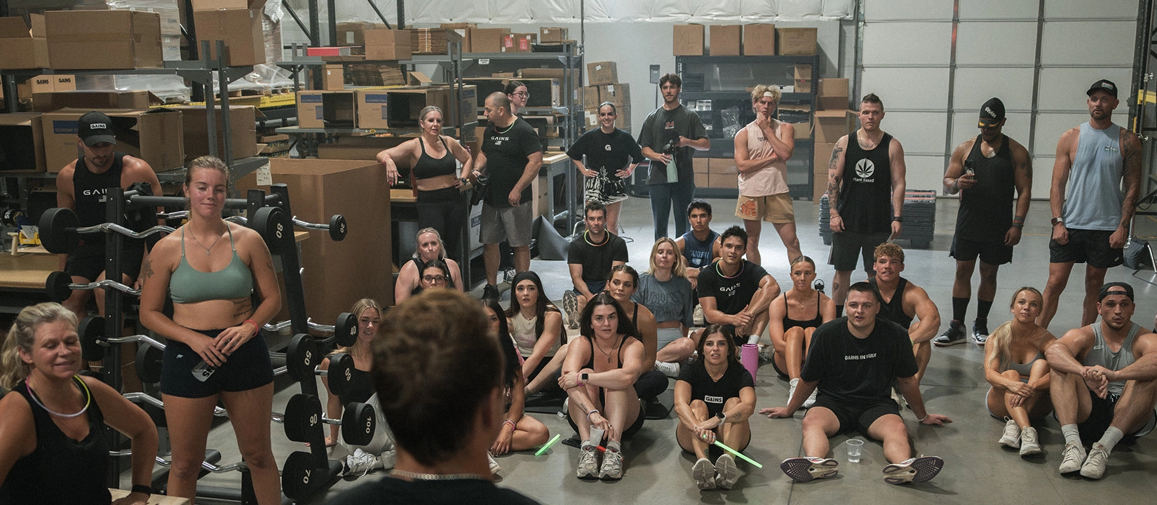 Large group of lifters gathered in a warehouse gym