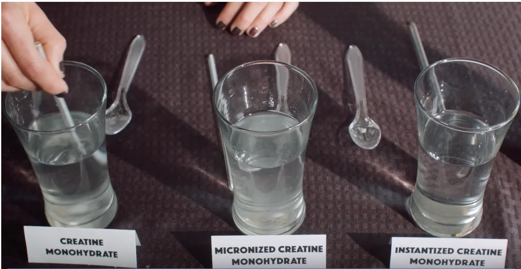 Three glasses of water with creatine and spoons, labeled by creatine type