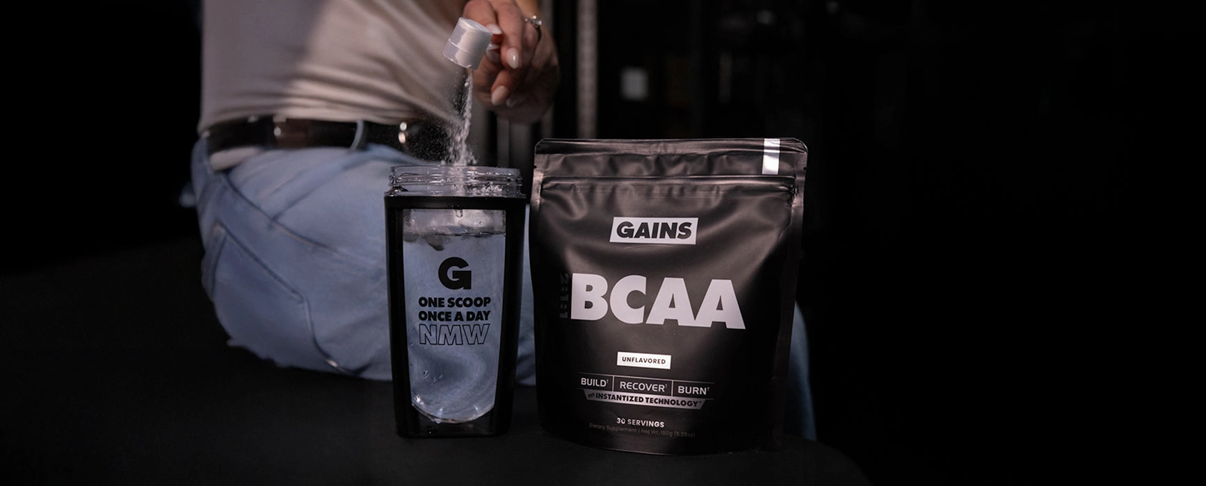 Glutamine and BCAA pouches on a dark table